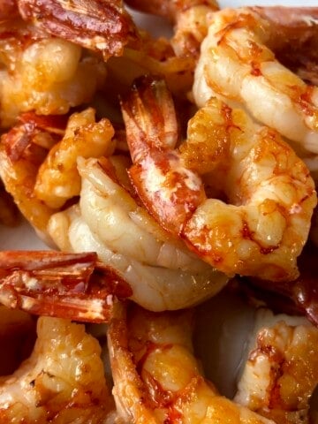 A pile of bright red-orange pan-seared sauteed Argentinian Red Shrimp perfectly cooked and tender.