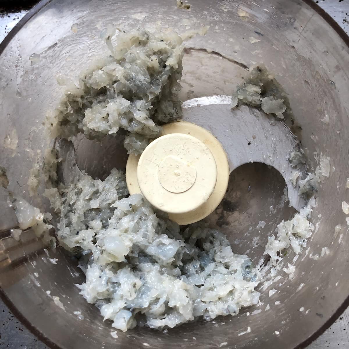 Processed shrimp toast mixture in food processor showing chunky texture with visible shrimp pieces for authentic Chinese shrimp toast recipe.