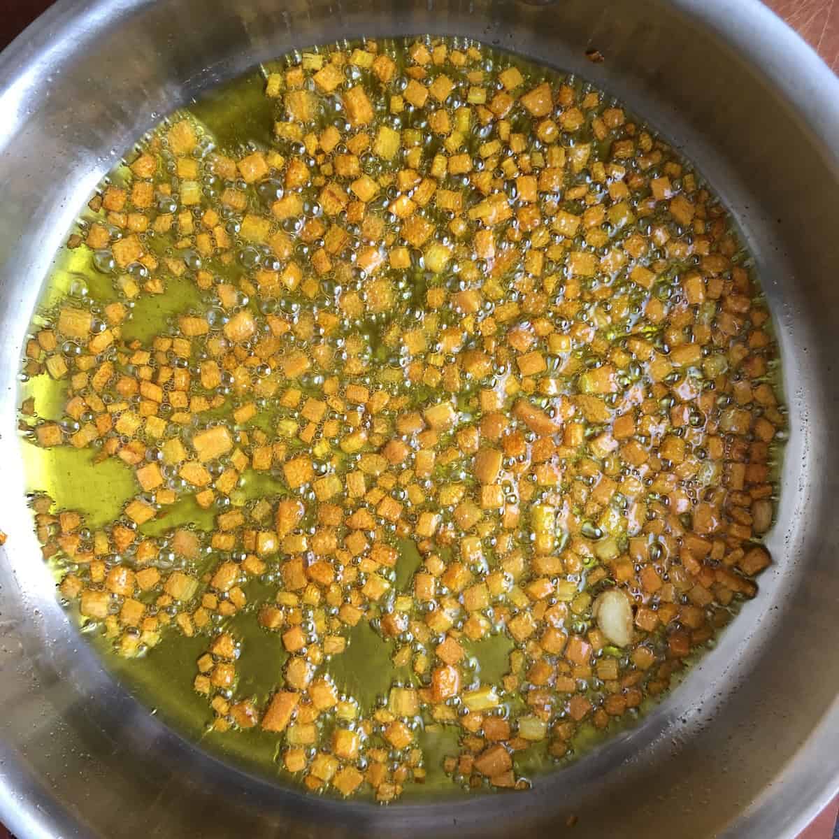 Caramelized carrots and blistered garlic ready for mushrooms to be added, building flavor for Italian mushroom pasta no cream.
