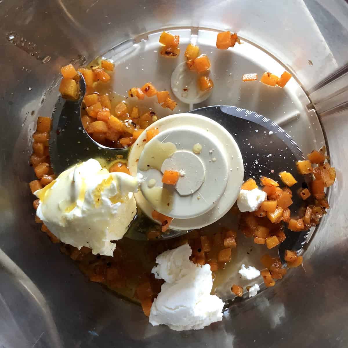 Caramelized carrot mixture added to food processor with ricotta cheese, mascarpone, leaf lard and crushed red pepper for lobster ravioli filling.
