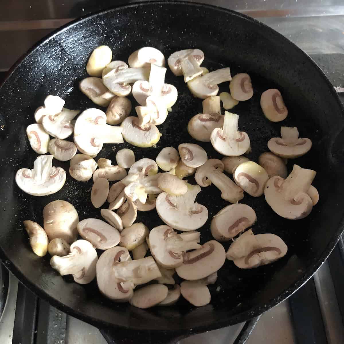 Fresh mushrooms added to the pan with caramelized carrots and garlic, learning how to cook mushrooms for pasta the Italian way.
