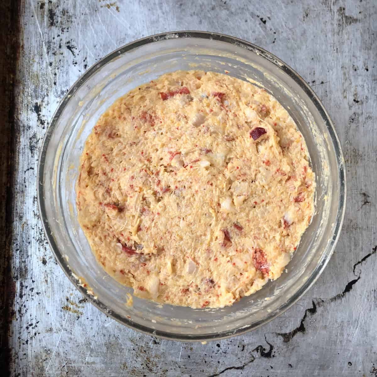 Lobster and shrimp ravioli filling smoothed in a bowl ready to cover and refrigerate until ready to use.
