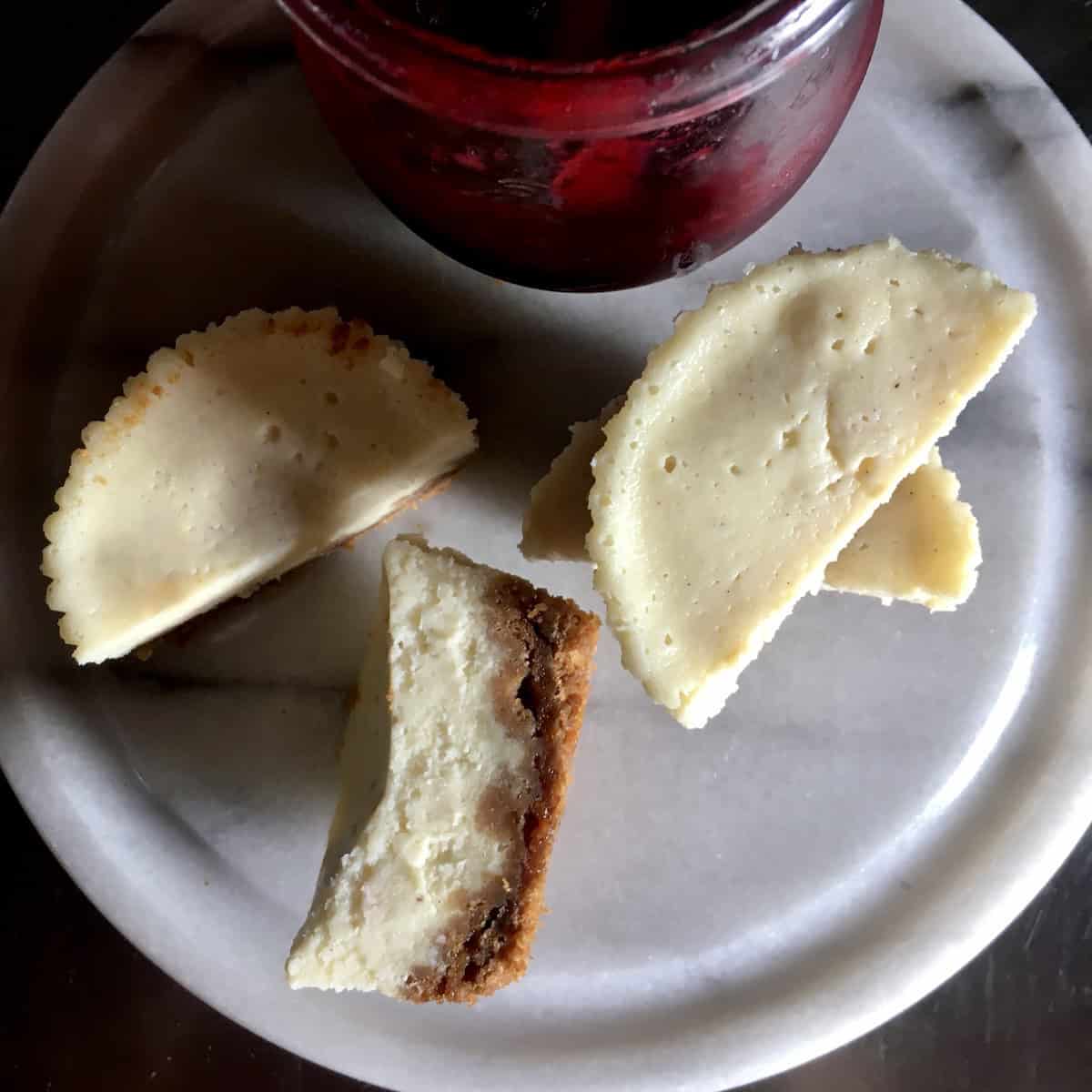 Mini vanilla bean cheesecake with Biscoff cookie crust topped with homemade wild berry sauce, easy no bake cheesecake recipe for individual desserts.