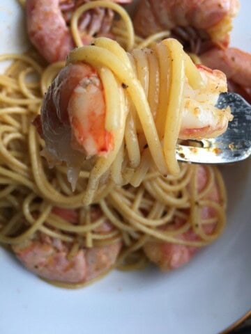 Cajun royal red shrimp tossed with spaghetti pasta in a spicy seasoned sauce, showing bright red gulf royal red shrimp over al dente spaghetti. A bold and flavorful lenten seafood pasta dinner.