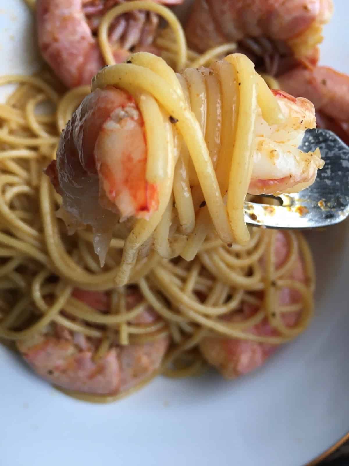 Cajun royal red shrimp tossed with spaghetti pasta in a spicy seasoned sauce, showing bright red gulf royal red shrimp over al dente spaghetti. A bold and flavorful lenten seafood pasta dinner.