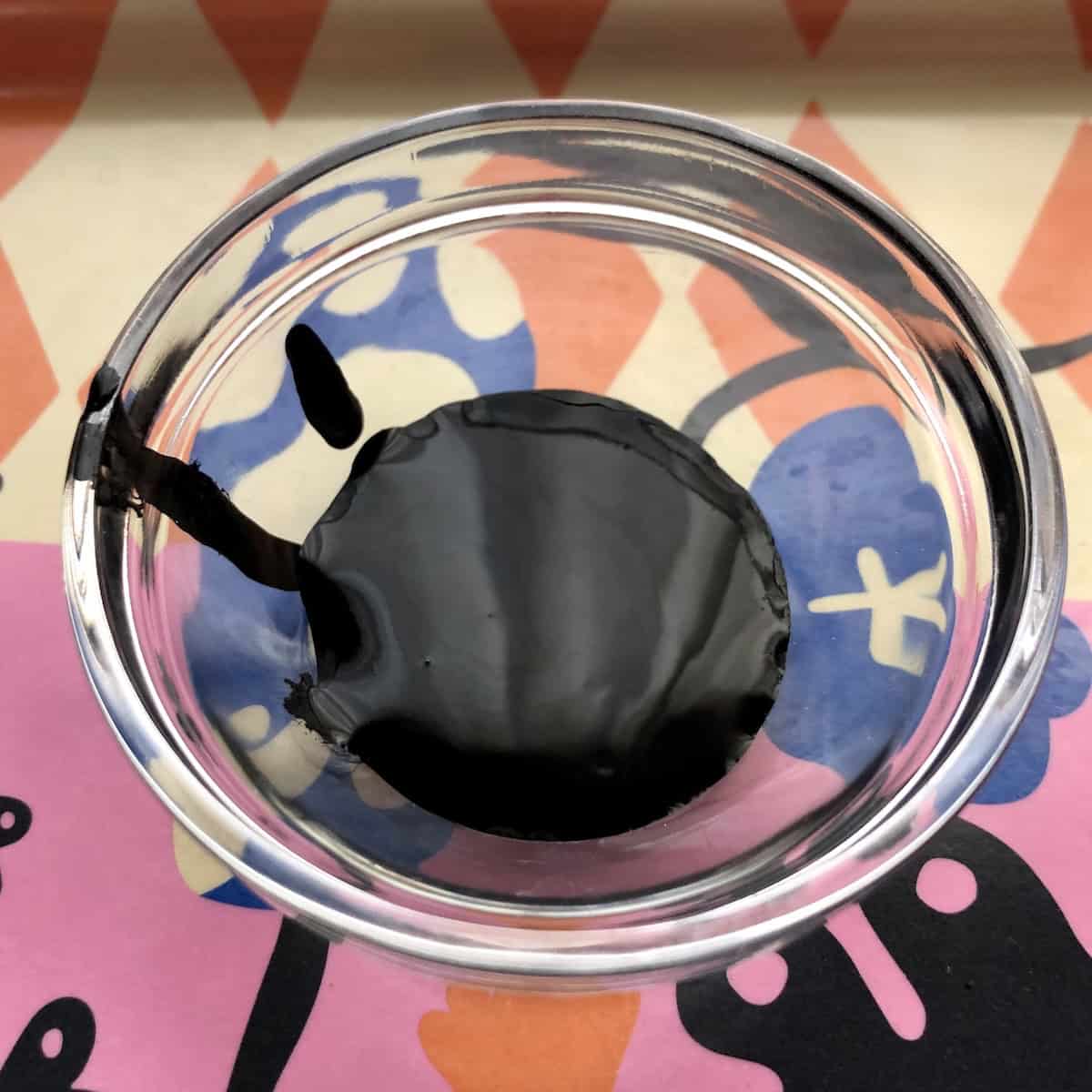 Riunione cuttlefish ink nero di seppia in small glass prep bowl showing the black squid ink used for homemade pasta recipe.

