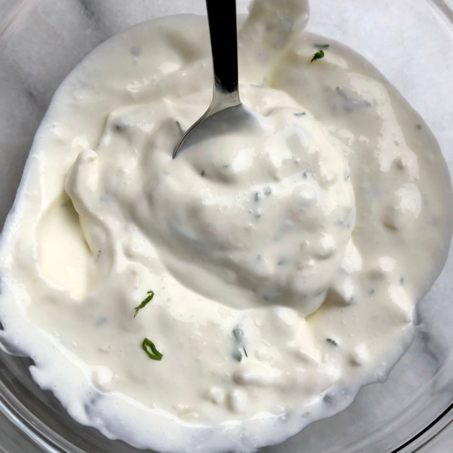 Creamy homemade French onion dip in a bowl after mixing, made from scratch with no dried soup mix, no MSG, and no preservatives or caramelized onions. A better-than-store-bought lenten party dip perfect for Lent gameday party snacks.