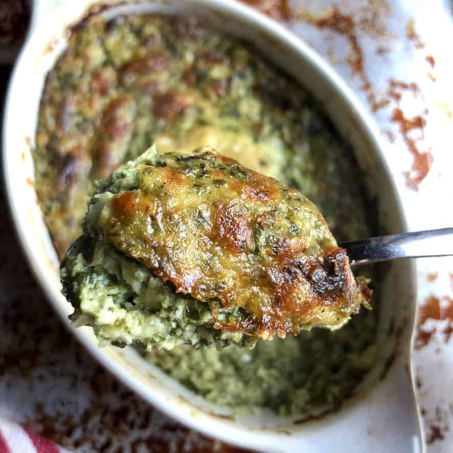 A spoonful of homemade spinach artichoke dip showing the ultra creamy, cheesy interior loaded with tender spinach and artichoke pieces. A must-make lenten party dip.