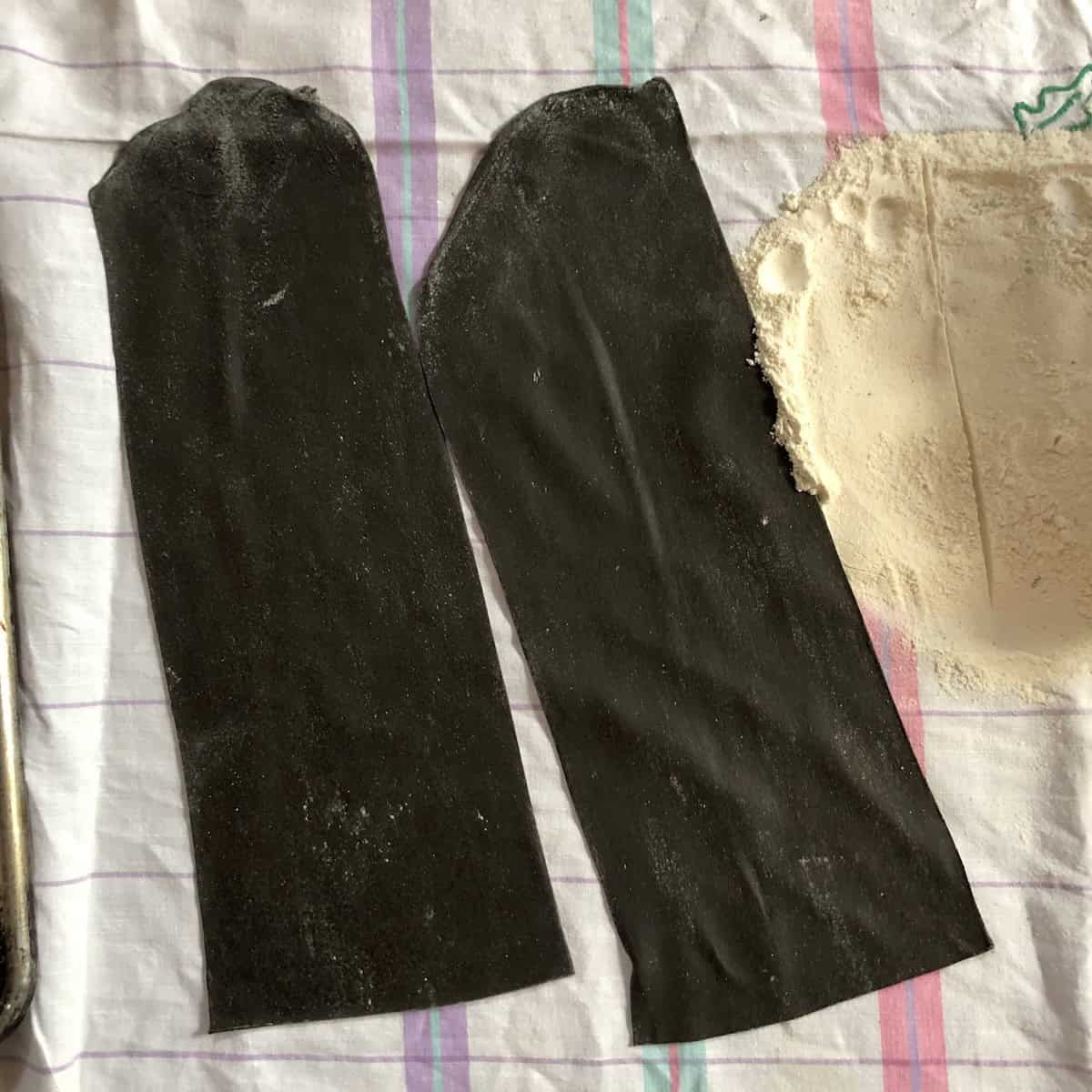 Homemade black lasagna noodles made with squid ink ready to use or freeze for cuttlefish ink pasta lasagna recipe.
