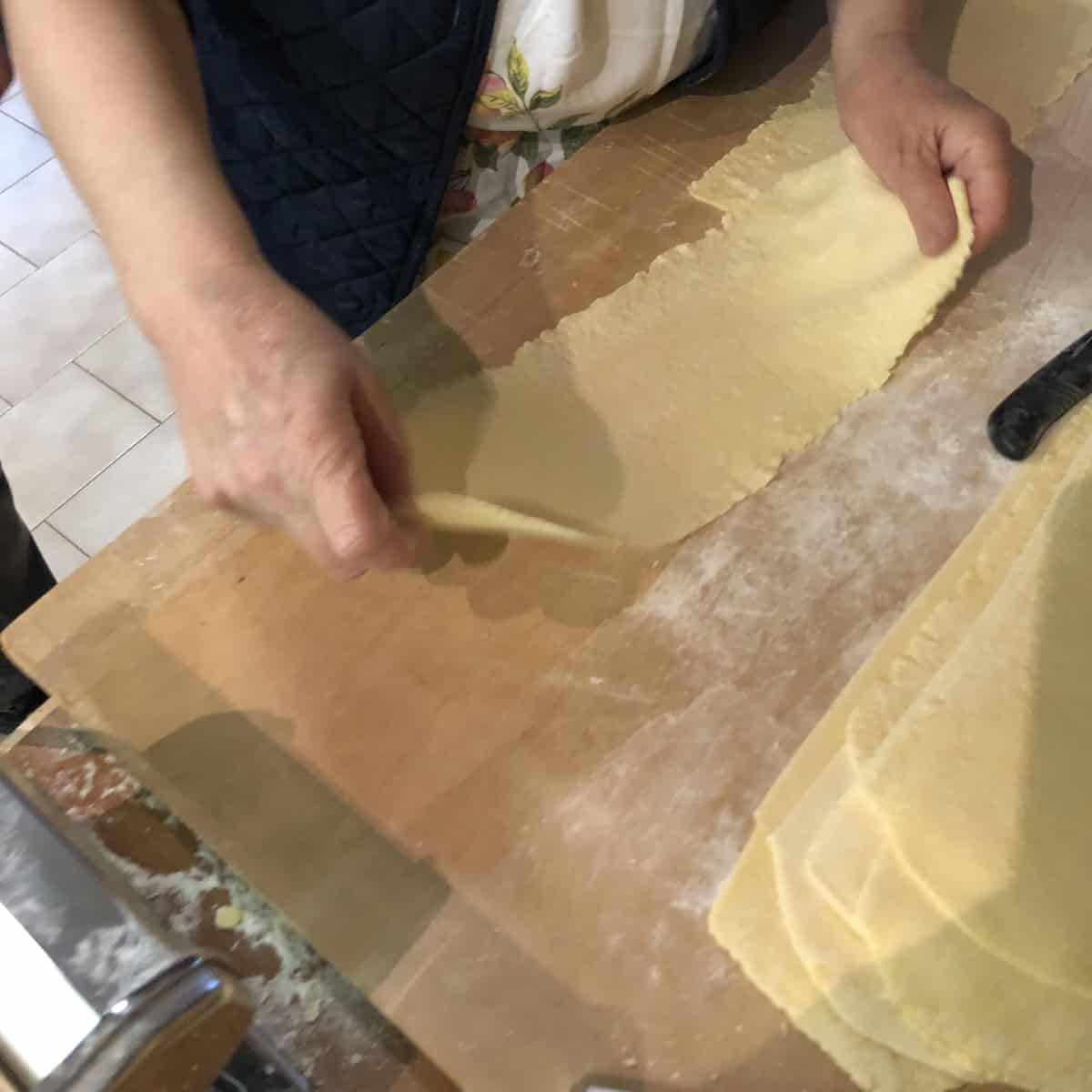 A fresh 00 flour pasta sheet rolled out and ready to fill with spinach and ricotta filling for Nonna Anna's traditional Italian ravioli filling recipe - ravioli ricotta e spinaci made for Easter.