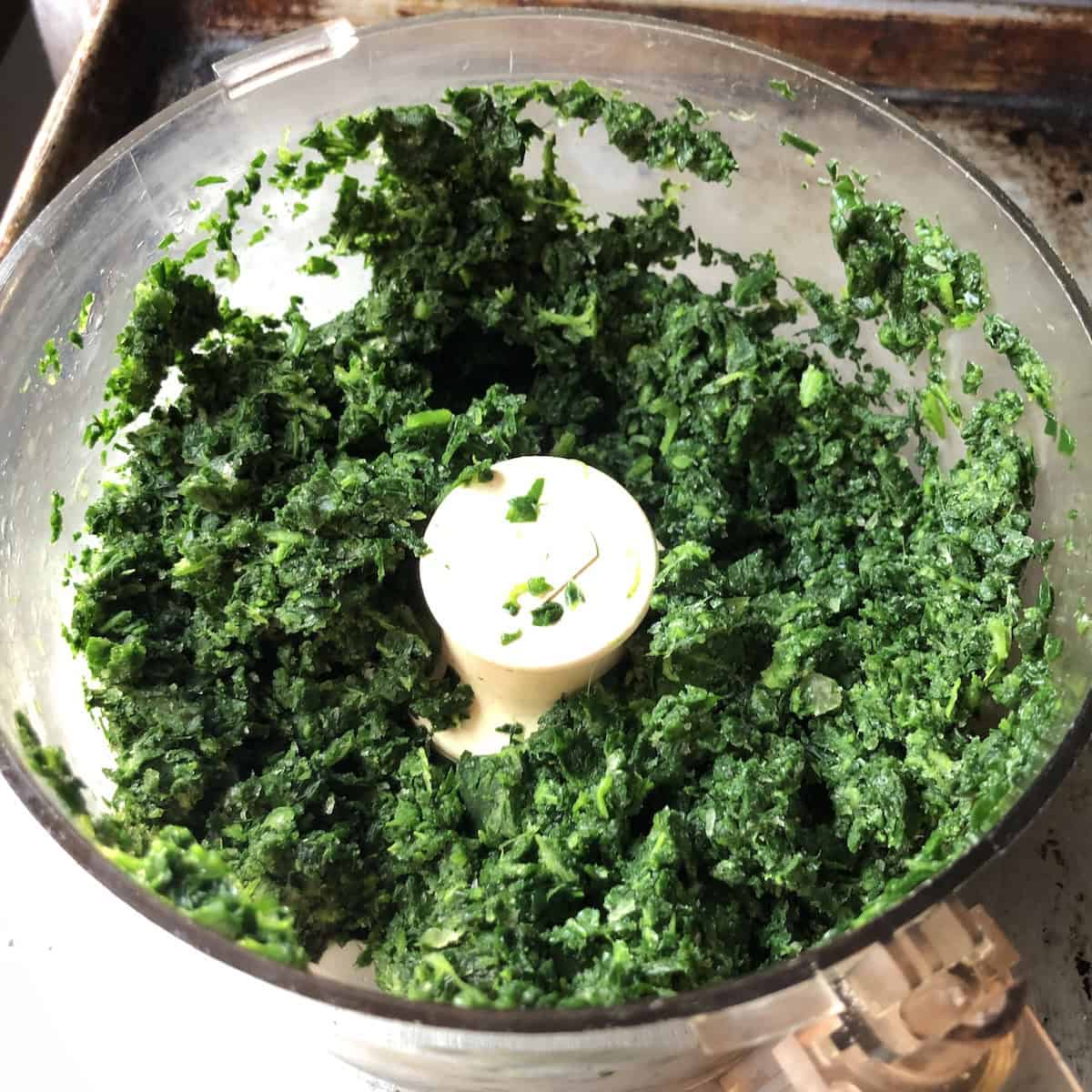 The correct size of food processor-pulsed spinach for an easy homemade ravioli filling - finely chopped but not pureed, so it holds texture inside the pasta.