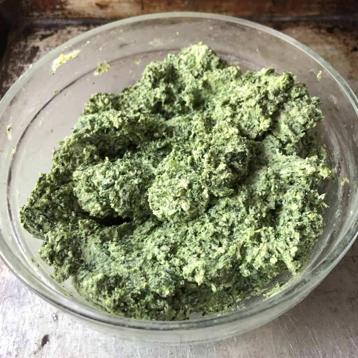 A bowl of the best homemade spinach and ricotta ravioli filling, perfectly seasoned and ready to fill fresh pasta sheets.