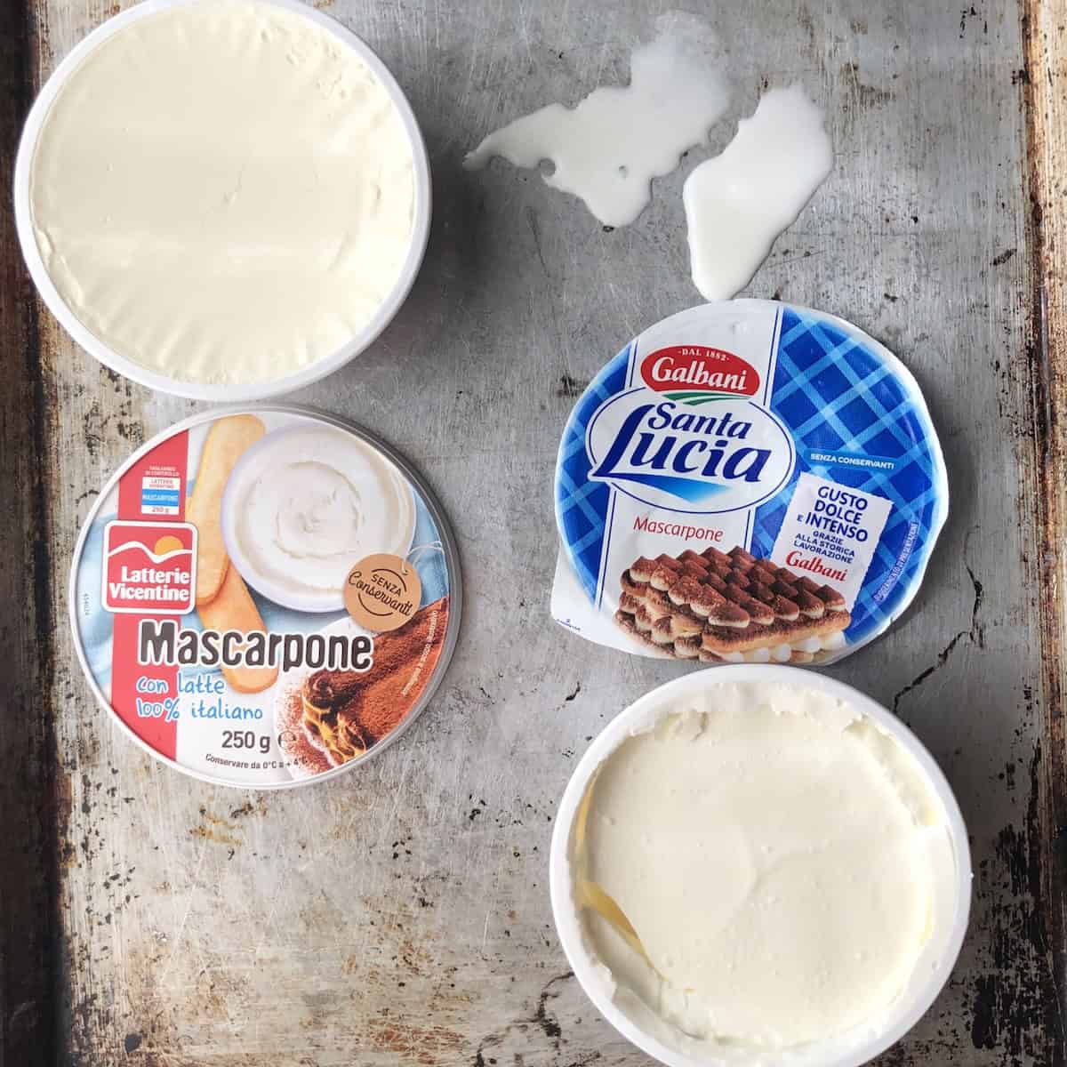 Liquid strained from Galbani mascarpone next to Latterie Vicentine showing why you need to strain watery mascarpone before making tiramisu cream.
