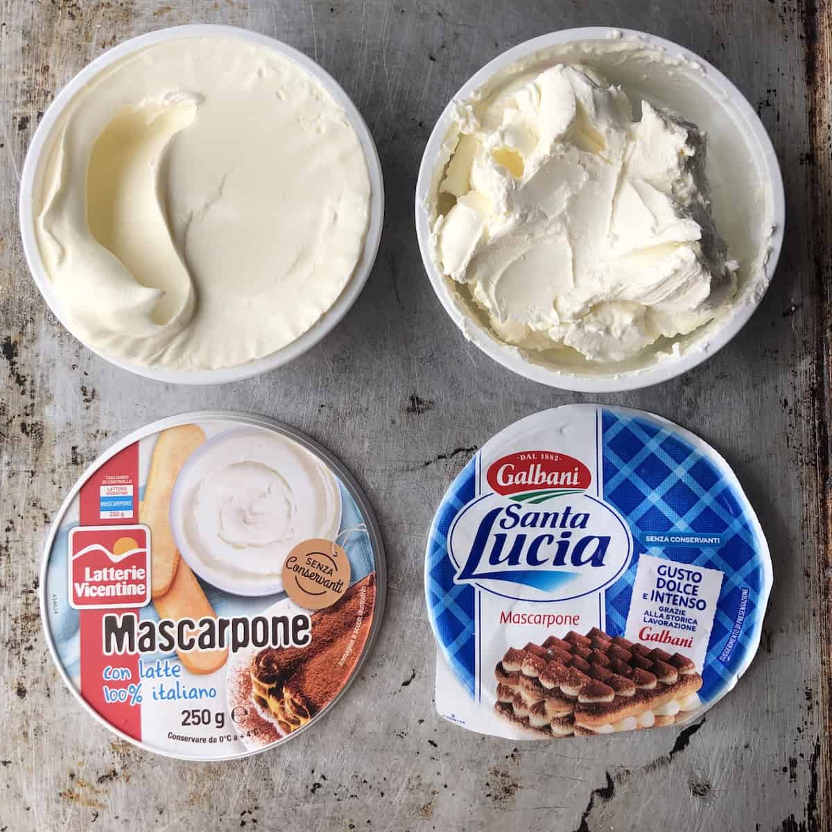 Two tubs of mascarpone with a spoon swiped through each showing superior texture of Latterie Vicentine made with lactic acid versus Galbani for tiramisu.