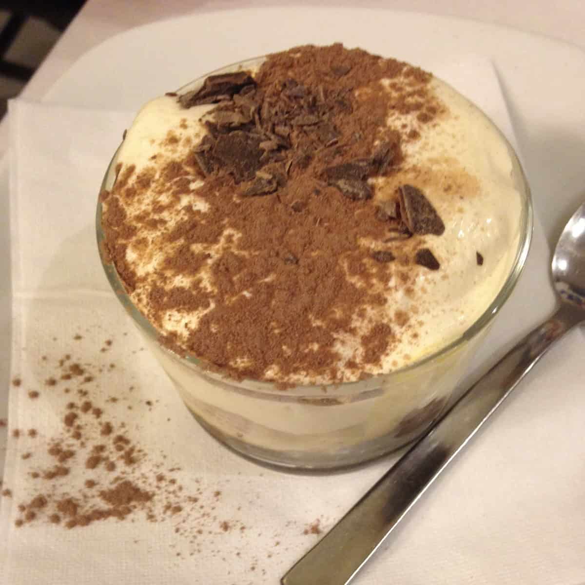 Individual mini tiramisu layered in a glass serving cup with super creamy tiramisu filling, dark chocolate garnish and less cocoa powder.