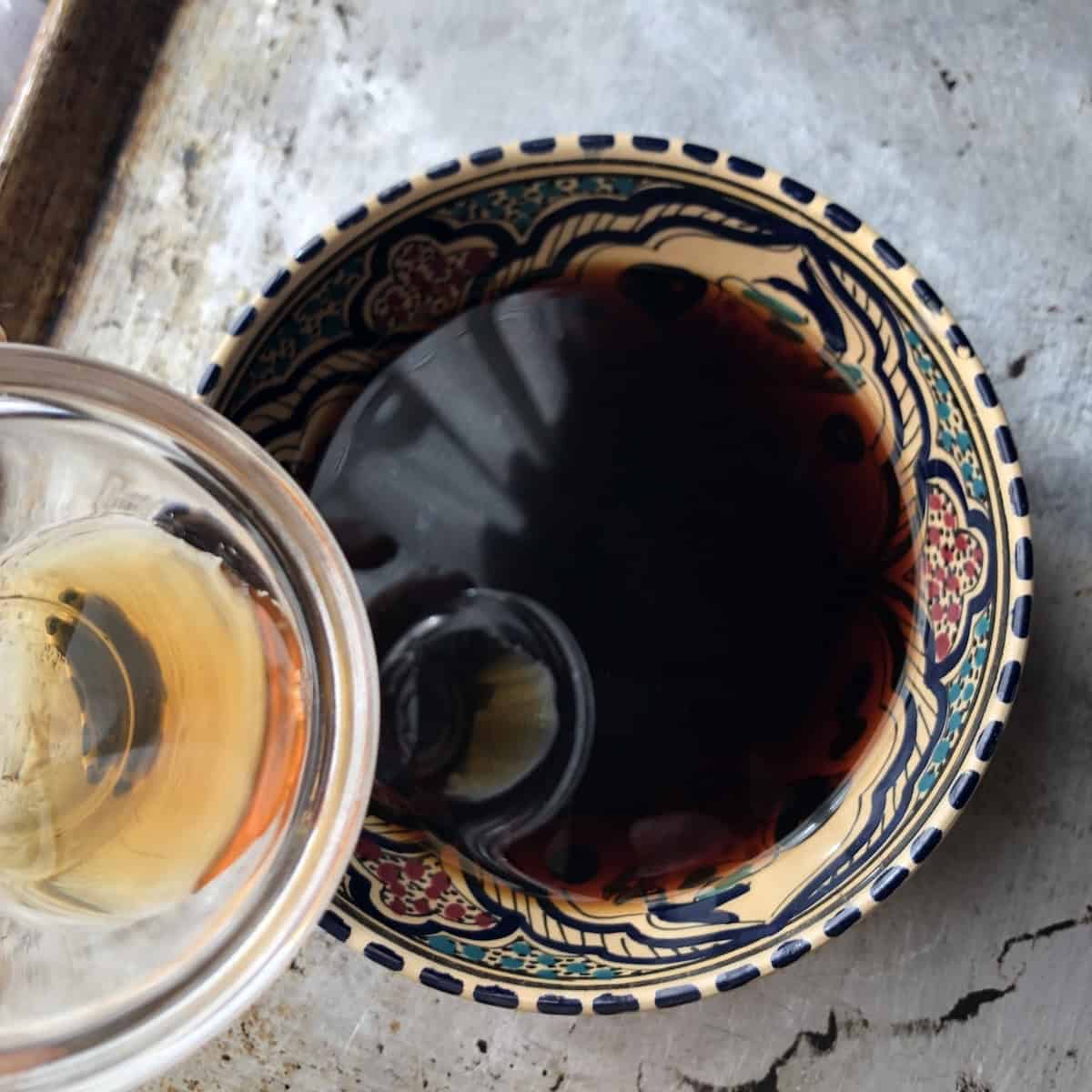 Adding dry marsala wine to espresso in a shallow wide bowl for soaking ladyfingers, traditional tiramisu method.