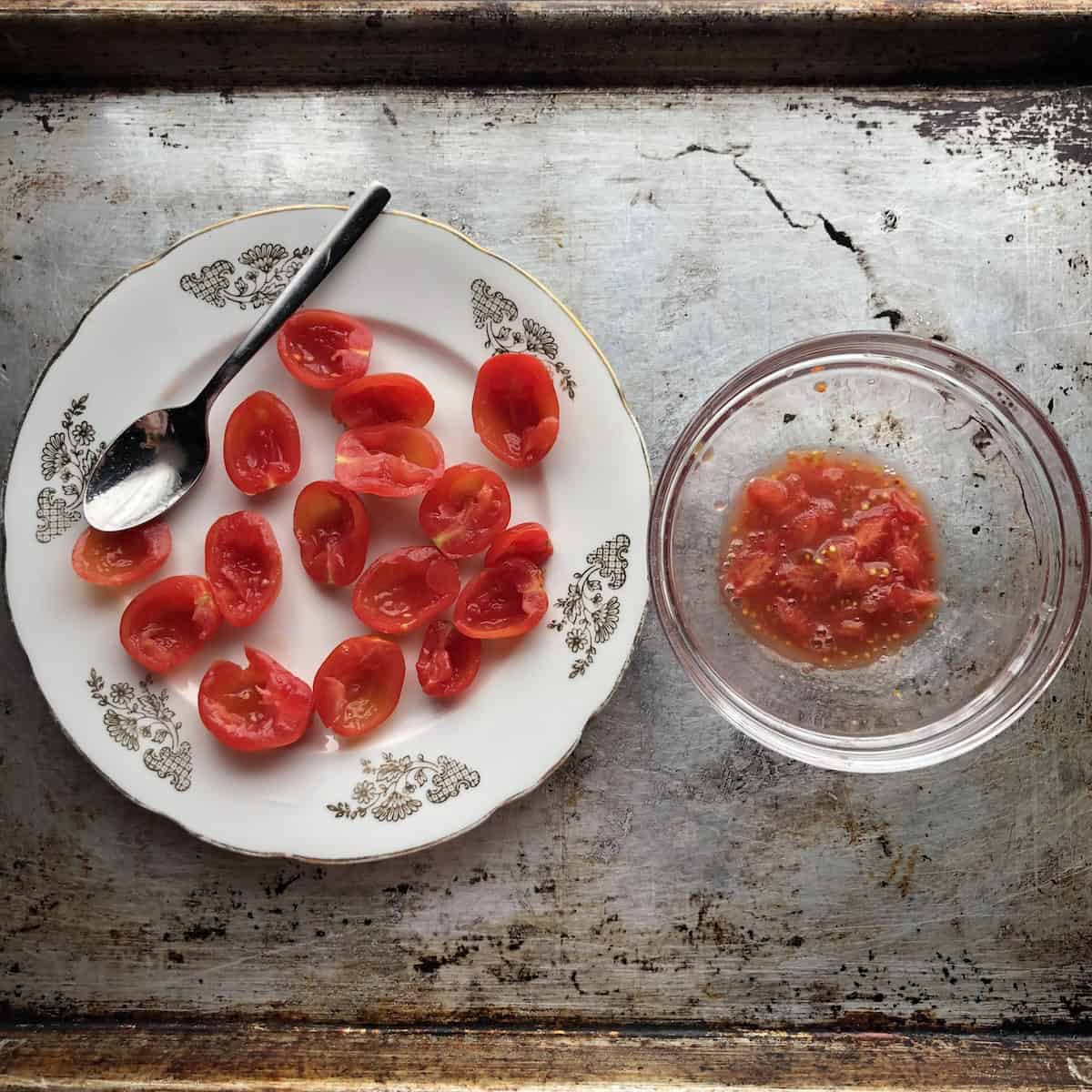 Grape tomato halves with seeds and membranes removed in a separate bowl for a guacamole that's not runny.