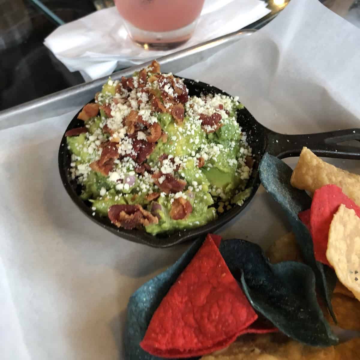 Guacamole topped with cotija cheese and bacon crumbles for a Mexican variation.
