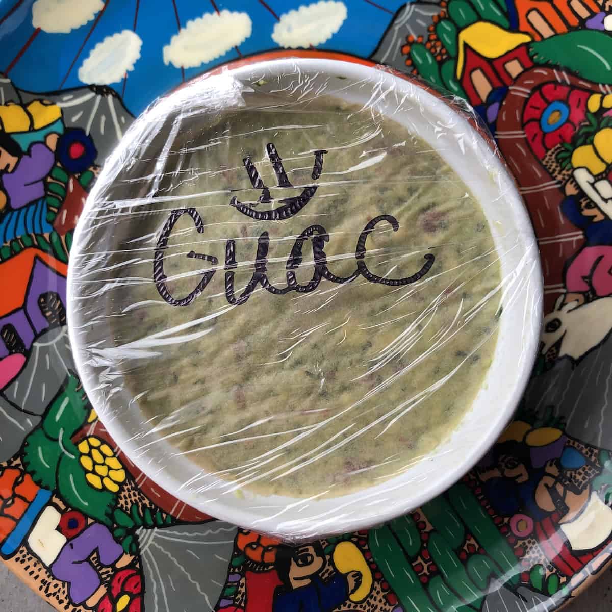 Guacamole wrapped in sustainable cling film ready to be refrigerated or frozen for storage.
