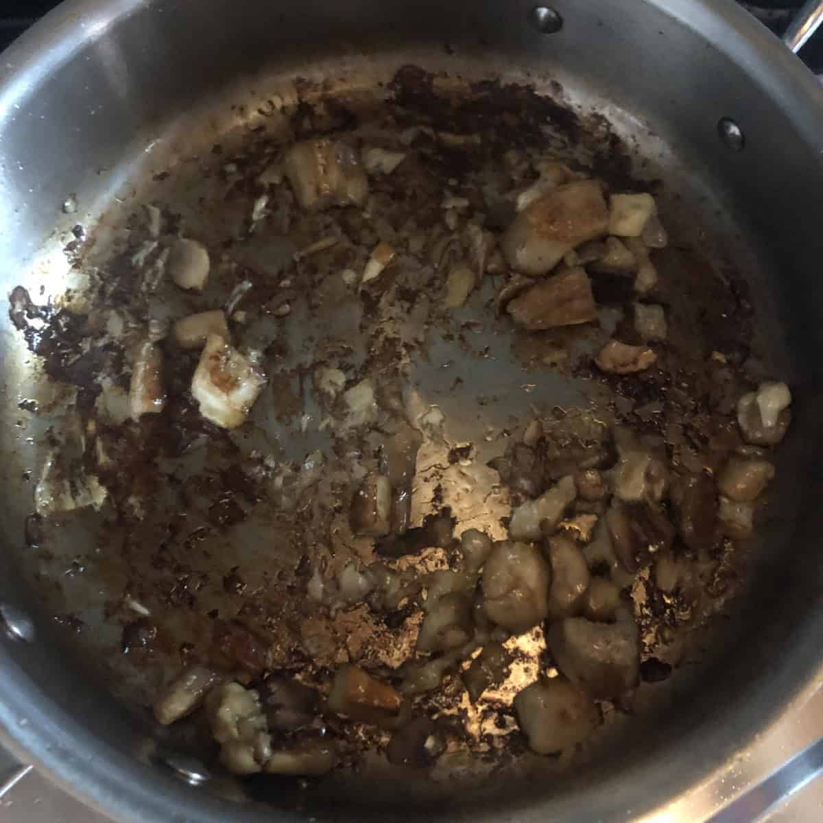 Sauteed porcini mushrooms with a rich fond built on the bottom of the pan, dried porcini mushroom recipes technique for a deep umami flavor in an authentic risotto recipe.
