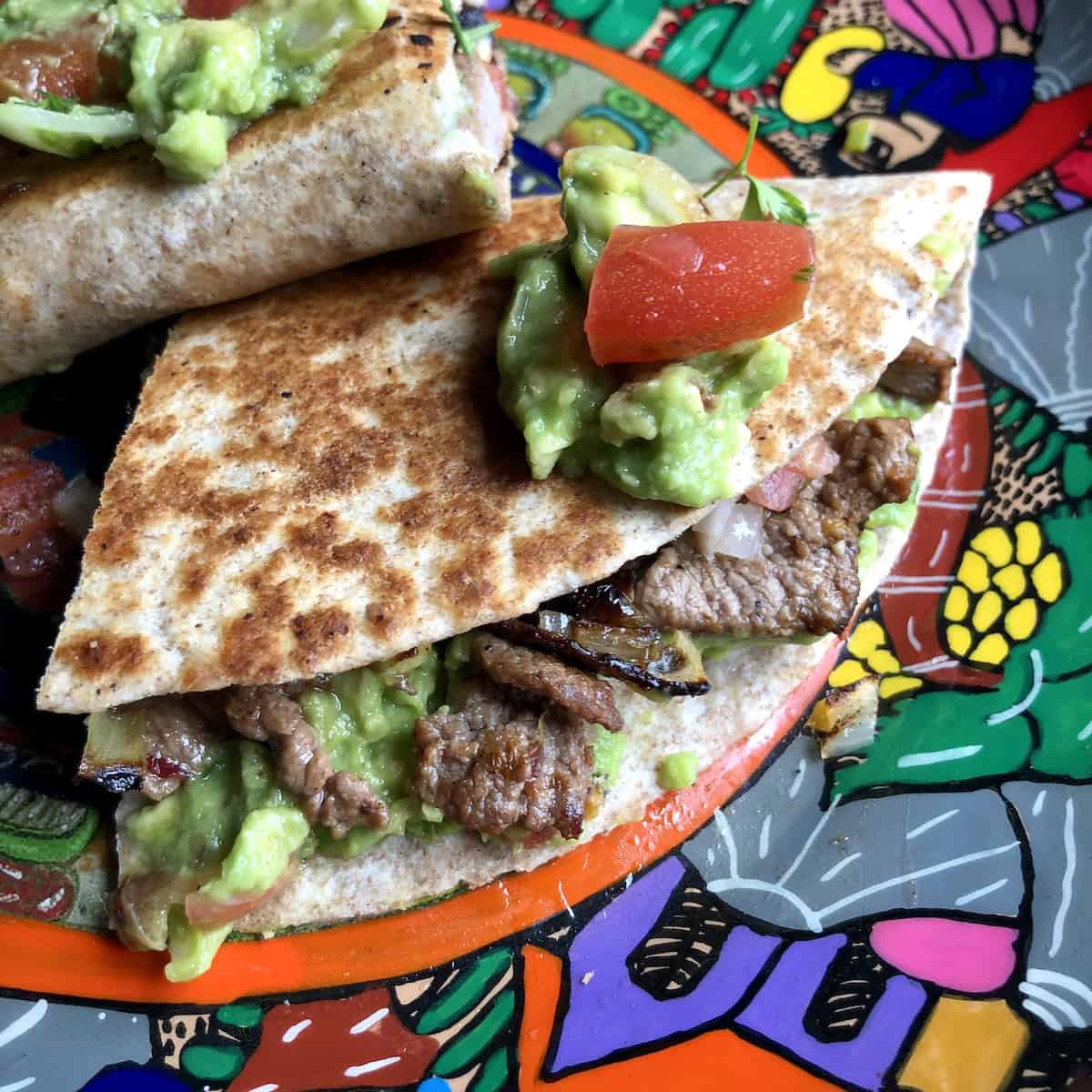 Beef quesadilla served with guacamole on the side.
