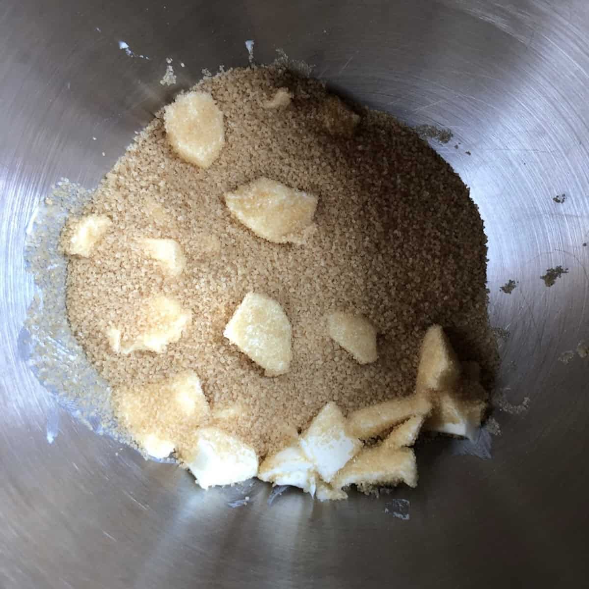 Butter and sugar in a stand mixer mixing bowl about to creamed together until light and fluffy to make coconut banana bread with chocolate chip batter


