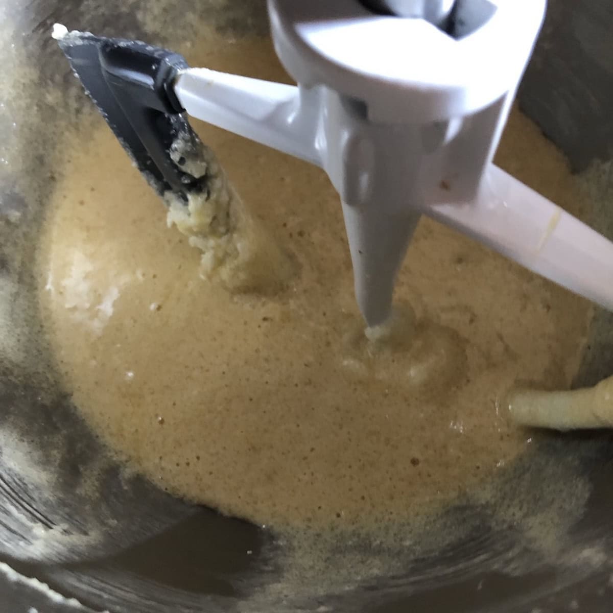 Coconut banana bread with chocolate chips batter after incorporating the eggs and vanilla into the creamed butter and sugar mixture. 
