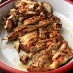 Grilled sliced pollo asado in a serving platter ready to be used for enchiladas, quesadillas, tortilla soup, fajitas, and more.