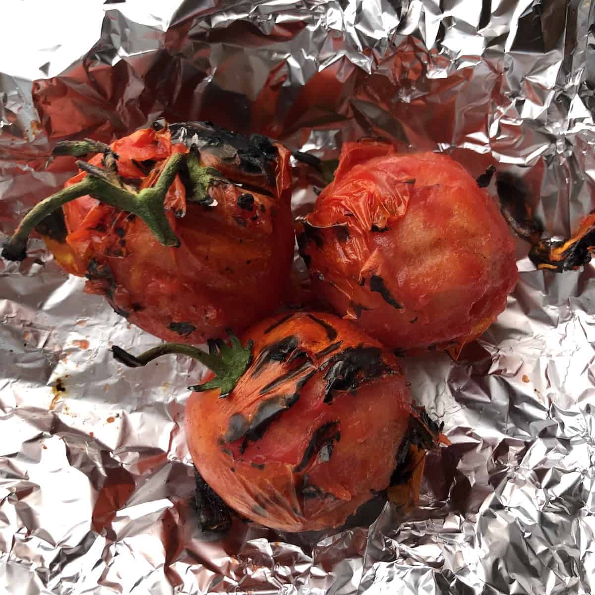 Fire-roasted tomatoes charred and blistered ready for an authentic tortilla soup recipe.
