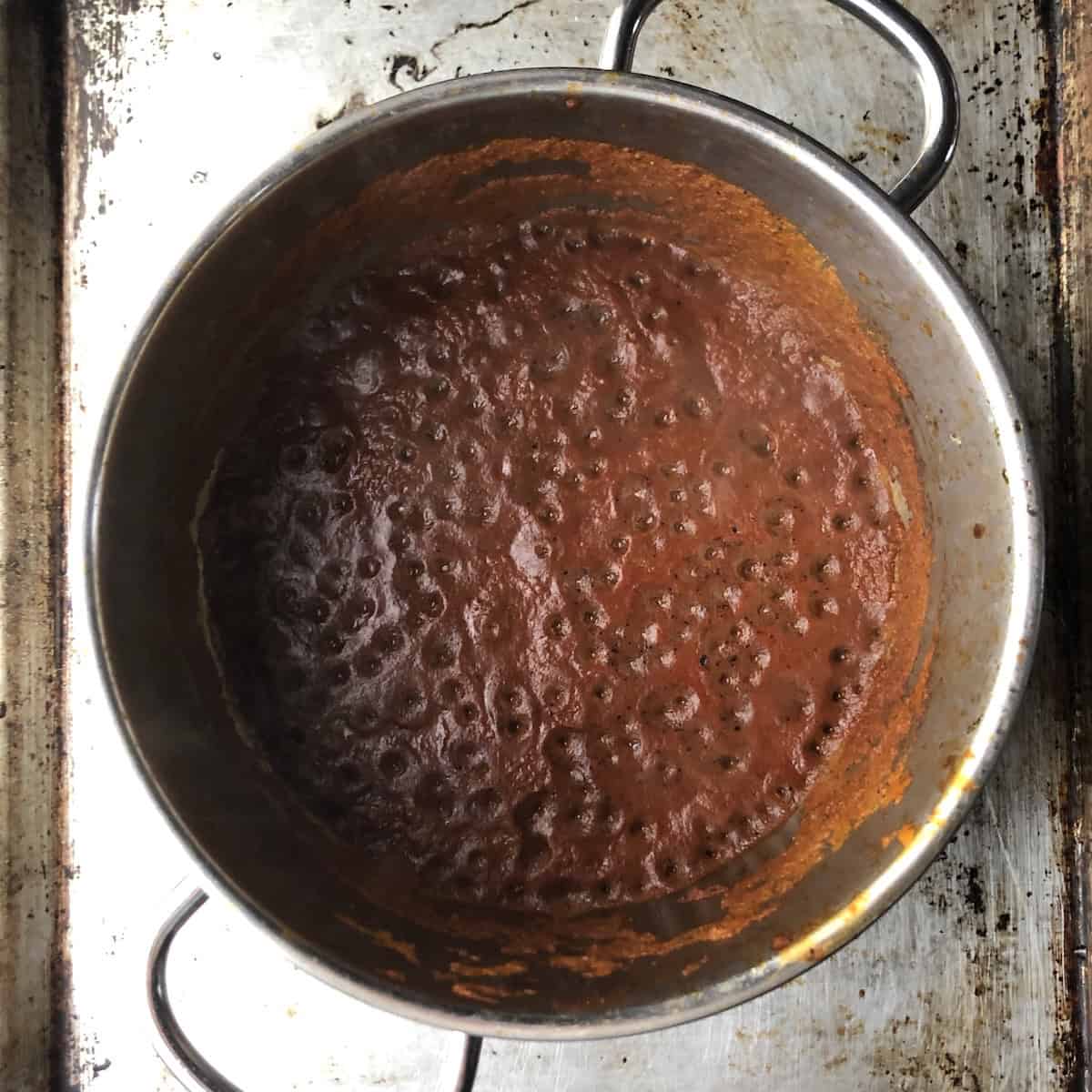 Reduced tomato chile mixture dark red in color and ready for the chicken broth to be added, how to make chicken tortilla soup
