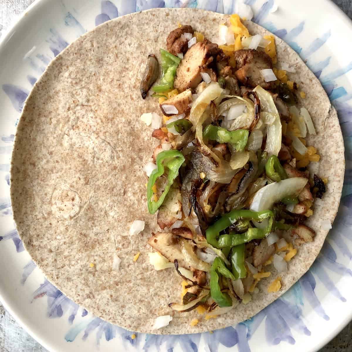 Caramelized onions and cubanelle peppers added to the filling for a mexican chicken quesadilla.
