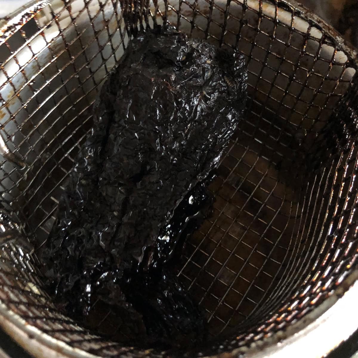 Frying a mulato chile in oil for a mexican chicken tortilla soup garnish.
