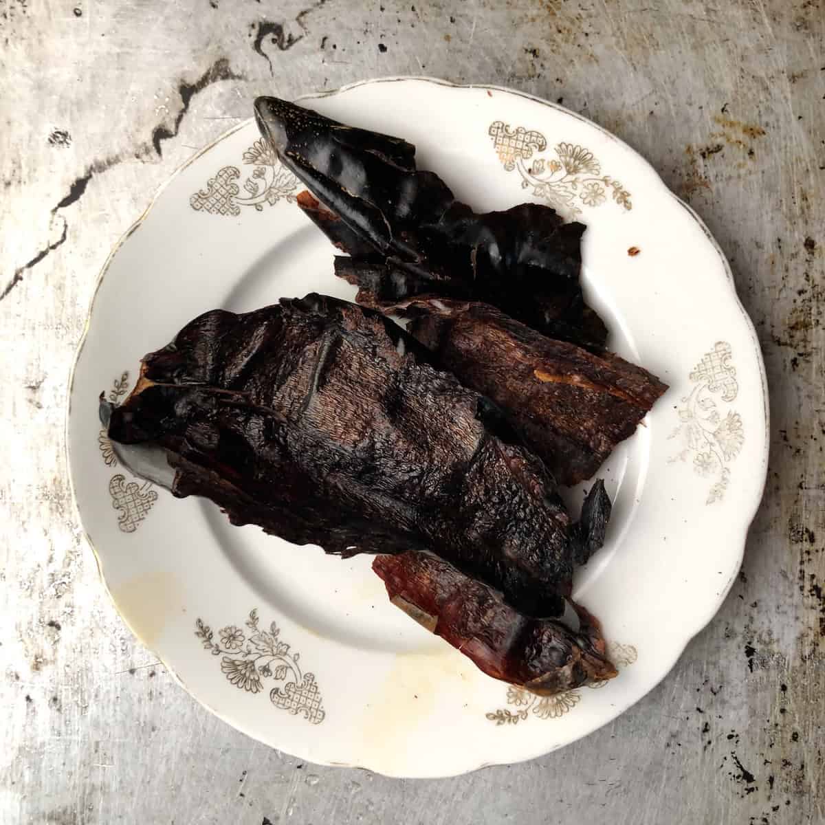 Toasted guajillo chiles seeded and stemmed on a plate ready for blending, tortilla soup recipe.
