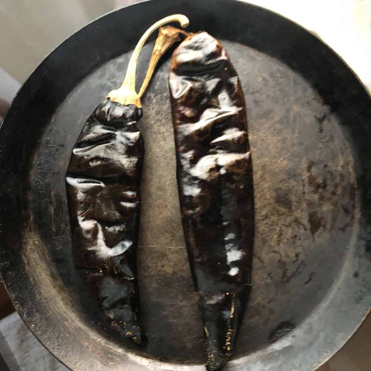 Slightly puffed and glossy guajillo chiles after toasting for one minute per side in a dry skillet for tortilla soup.
