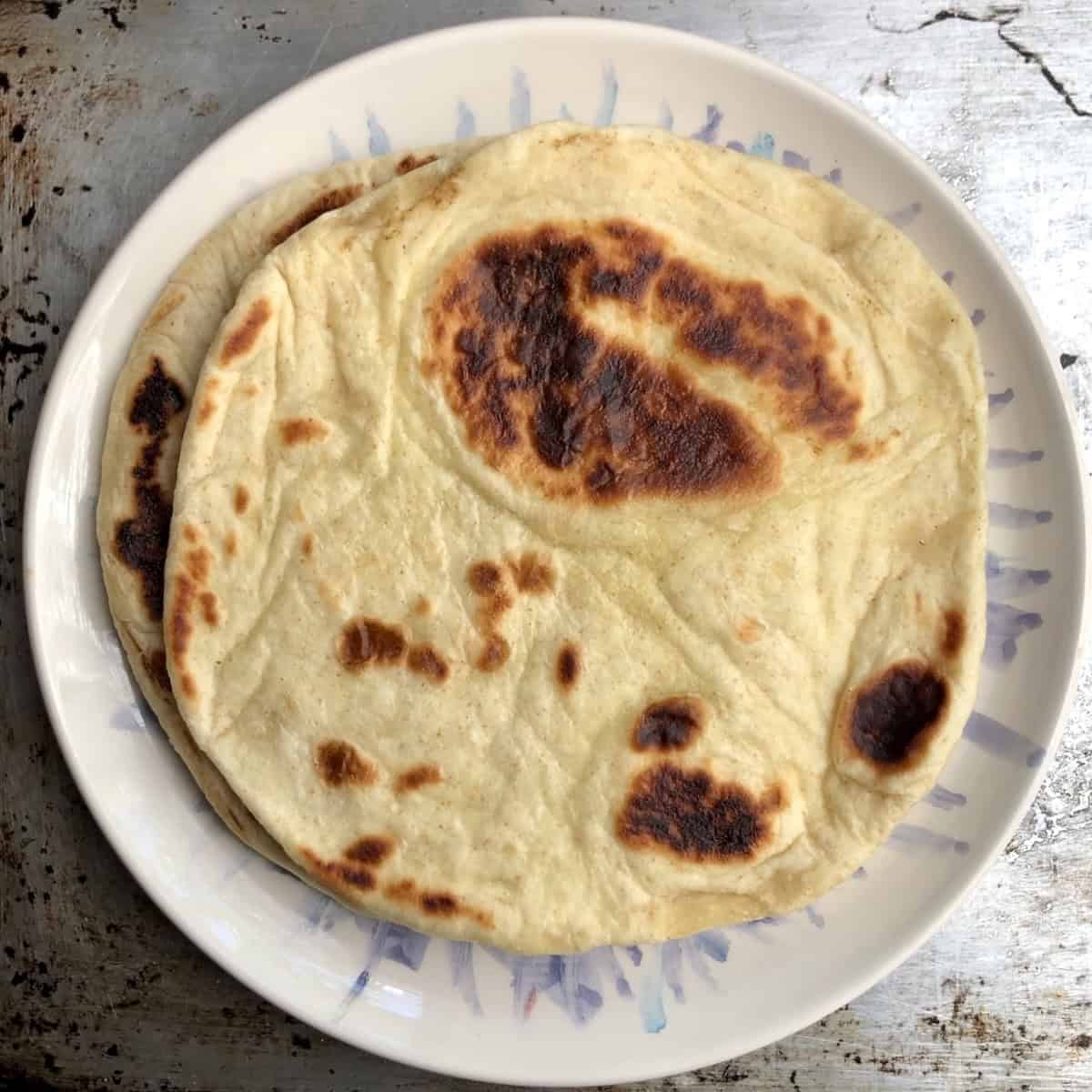 Stack of warm Greek gyro bread ready for serving.